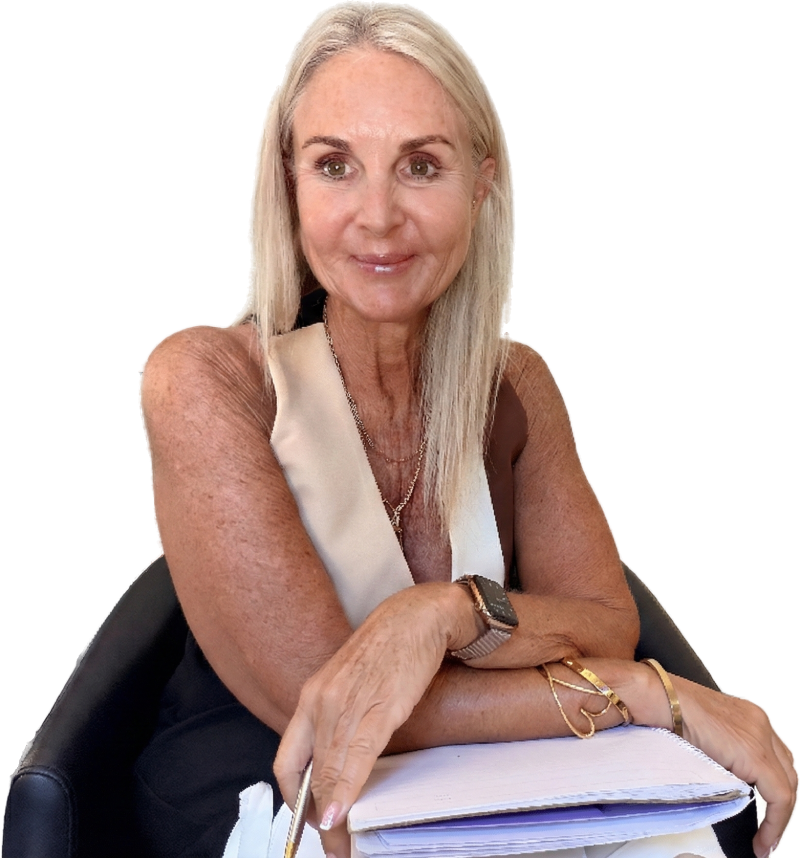 Kerryn seated leaning forward with writing pad